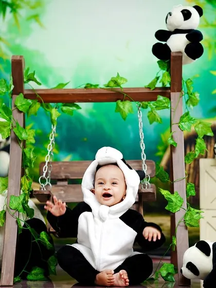 A happy little panda, laughing and playing in our bamboo forest-themed studio.
