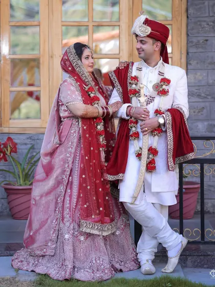 A classic portrait of the bride and groom in their wedding attire, showcasing a beautiful Himachali wedding.