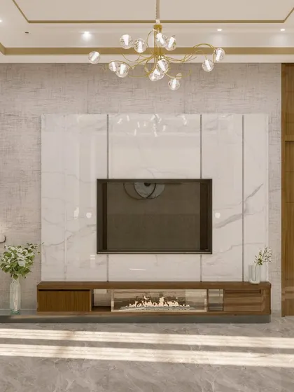 The TV unit in the 'Golden Glam' room features a white marble panel and an electric fireplace for added warmth and ambiance.