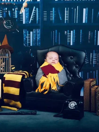 Our littlest wizard sleeping peacefully in the Gryffindor common room. This elaborate Harry Potter set is perfect for newborns, as we can pose them safely while they dream.