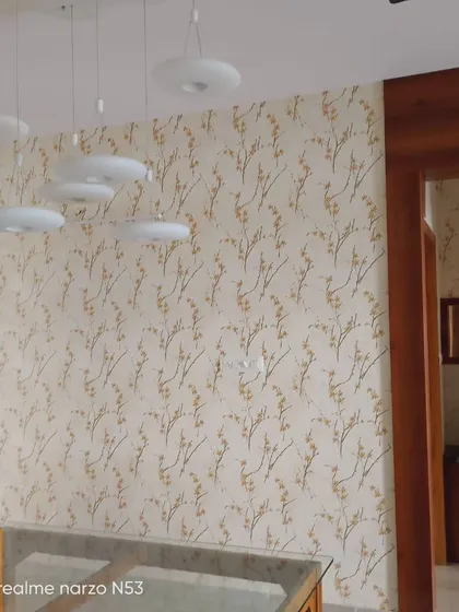 A delicate branch wallpaper in a hallway.