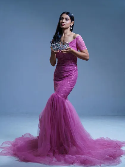 A powerful portrait of the pageant winner, exuding confidence and grace in the pink mermaid gown.