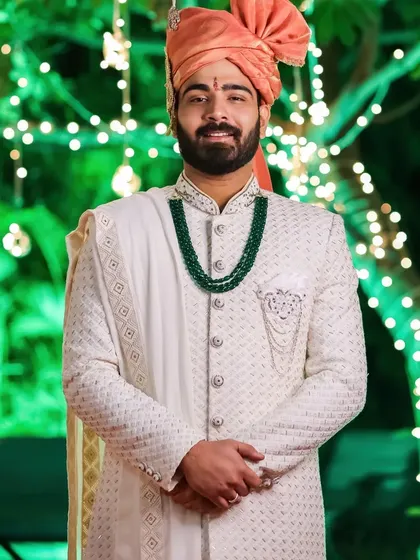A closer look at a cream Lakhnavi sherwani detailed with salli work. The texture of the Lakhnavi fabric combined with the subtle embroidery creates a sophisticated and timeless wedding outfit.