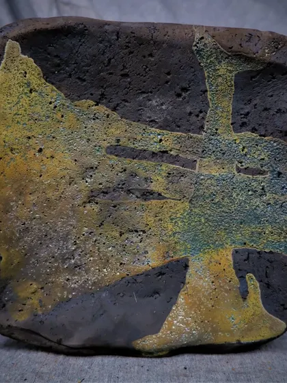 An abstract, textured tile finished with the Raku technique. This piece was made to announce one of my workshops, showcasing the kind of painterly and dramatic effects that are possible.