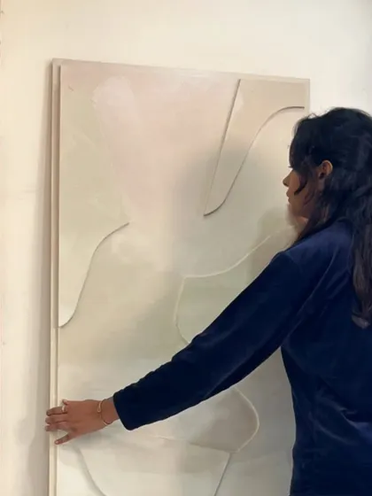 Here I am with a large 67" x 22" minimalist sculptural piece for a home in Hyderabad. The subtle, raised lines on a pearlescent background create a very serene and elegant effect.