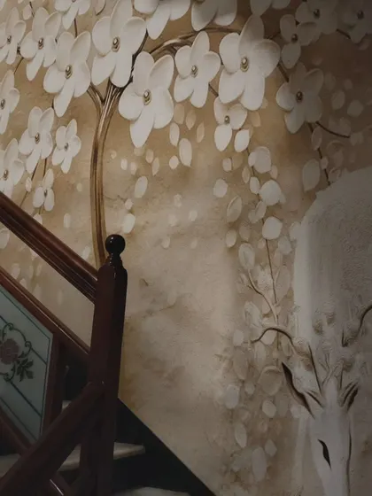 Another angle of the staircase mural, showing the detail of the deer and the 3D flowers.