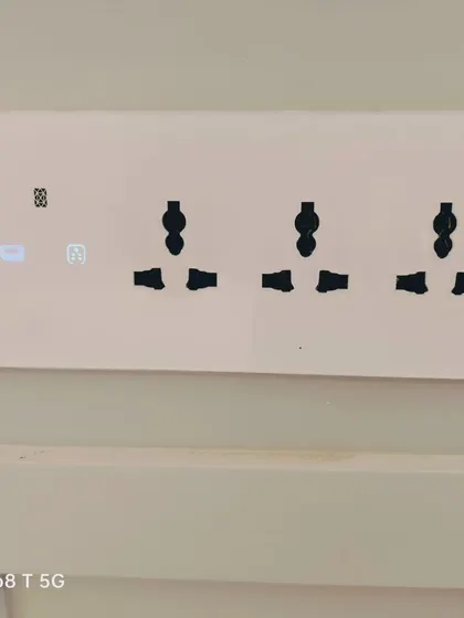 Simplicity and function combined. This minimalist smart switch panel features essential controls alongside three standard power sockets, demonstrating how we integrate smart technology with everyday utility.