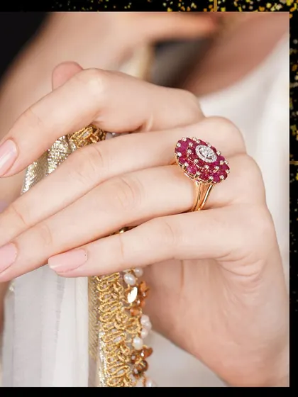 A moment of quiet reflection, with a beautiful ruby and diamond ring taking center stage. The piece is a classic floral cluster, symbolizing passion and timeless beauty.
