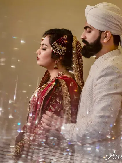 An artistic portrait using a prism to create a dreamy, light-filled effect. The couple stands in a serene pose, giving the image a spiritual, Sufi-like feel.