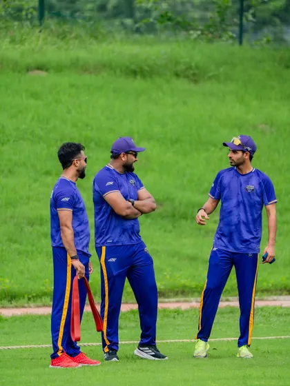 A candid conversation on the field. Building a strong rapport with players and fellow coaches is essential for a cohesive and successful team environment.