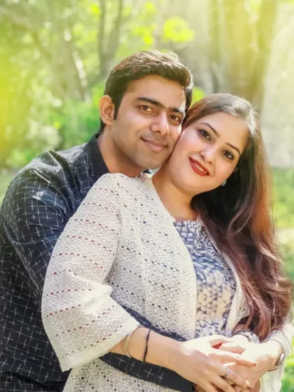 A classic and warm portrait of a couple embracing during their pre-wedding shoot in a park.
