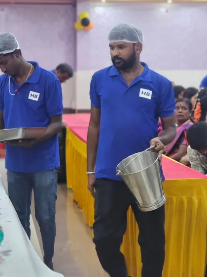 Our uniformed staff moving efficiently between rows to serve guests during a large event. We work hard to keep the service smooth and timely for everyone.