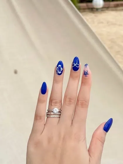 A stunning cobalt blue set with delicate, hand-painted white floral and bow details. The contrast is absolutely beautiful.