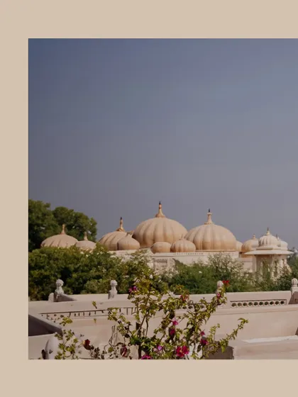The iconic domes of The Oberoi Udaivilas against a clear blue sky, setting the scene for a luxurious wedding.