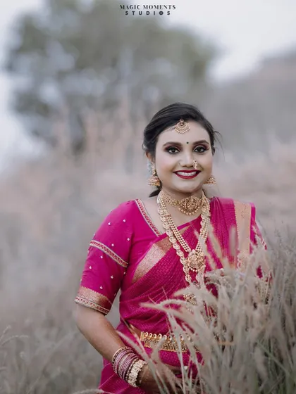 A beautiful portrait of the bride framed by the soft, feathery grass. This composition adds texture and depth to the photo.