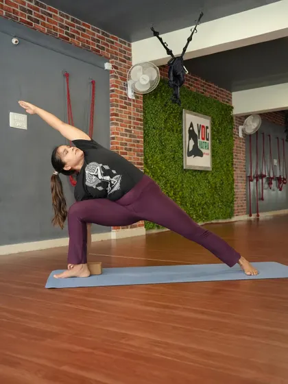 Utthita Parsvakonasana (Extended Side Angle Pose) with a block for support, focusing on creating a long line of energy from my heel to my fingertips.