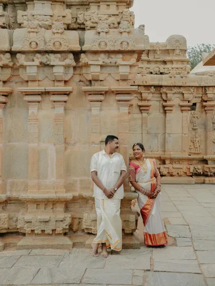 A happy, relaxed portrait of the couple standing in front of a beautifully carved temple wall. Their comfortable smiles show the easy-going and enjoyable atmosphere I create during my shoots.