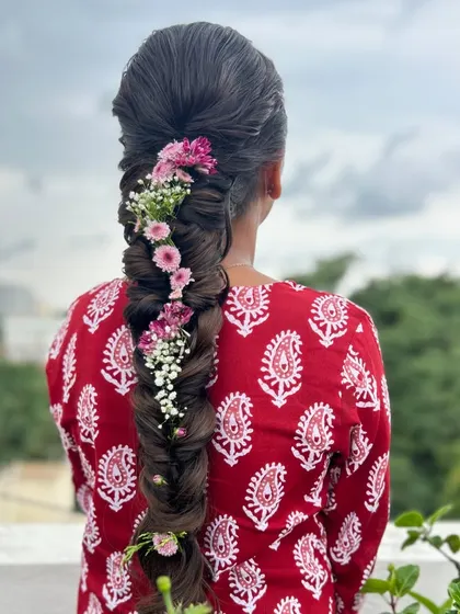 A beautiful shot of the floral fishtail braid against a natural background, perfect for a daytime event.