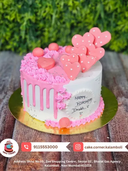 A lovely half-drip cake in pink and white, decorated with pink hearts. This sweet design is perfect for celebrating Drishti's birthday with love.