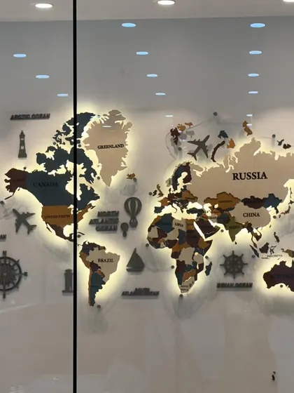 A custom backlit world map designed for a corporate boardroom. Made from layers of MDF and acrylic, this piece is both decorative and functional. The warm backlighting creates a sophisticated glow, highlighting the different continents and making it a stunning centerpiece.