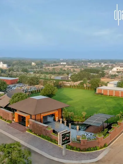The farmhouse is designed to host large gatherings, with a sprawling green lawn providing a versatile outdoor venue space.