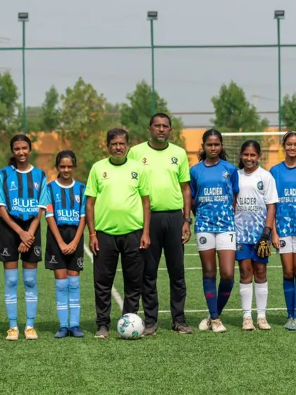Our girls' team stands with their coaches for a group photo, a proud and united squad.