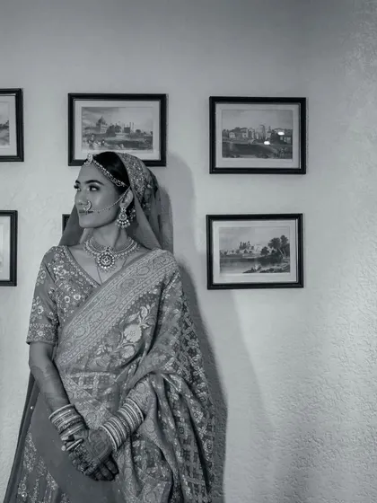 A timeless black and white portrait of a bride, her thoughtful gaze directed away from the camera, creating a classic, contemplative mood.
