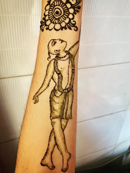 The completed Gaura Hari henna tattoo, shown with the fresh paste. This design is a form of devotional art, perfect for spiritual occasions or as a personal expression of faith.