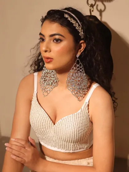 Another look from the same shoot, this time with a bit more glam. The shimmery eyeshadow and statement earrings elevate the look.