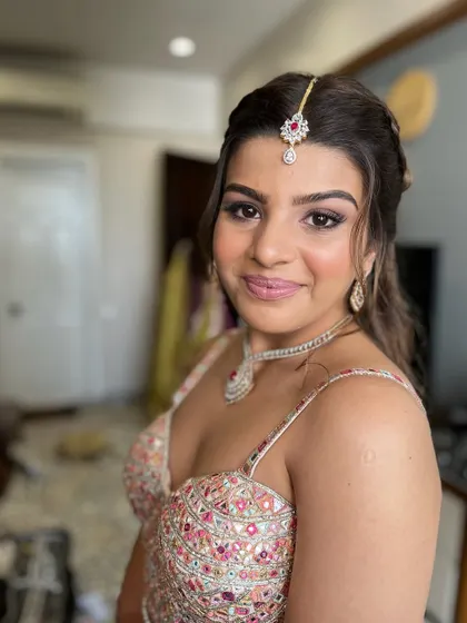 All glammed up and ready to go. This look features soft, shimmering eyes and a pink lip, perfect for a wedding guest in a beautiful embellished lehenga.
