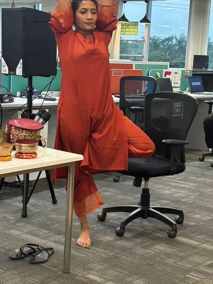 A desk yoga session at MagicBricks for International Yoga Day. Here I demonstrate a Tree Pose variation using an office chair for support, making yoga accessible at your desk.