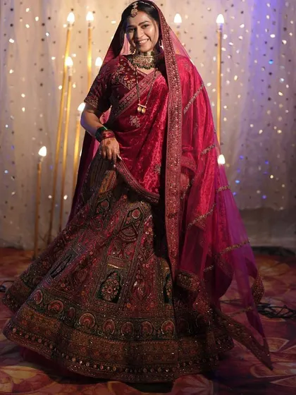 Here is to the bride in all her glory. This classic red bridal lehenga features intricate embroidery and a timeless silhouette, perfect for making your grand entrance on your wedding day.