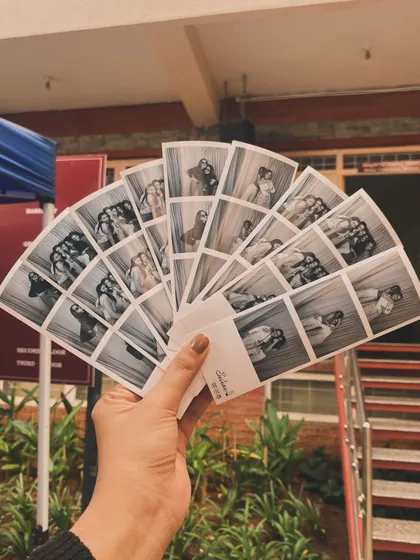 A fan of black and white photo strips, showcasing the variety of poses and moments captured.