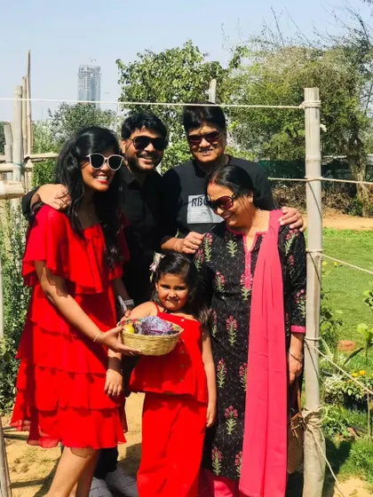 A happy family posing together after a fun day of harvesting, showcasing the multi-generational appeal of a farm outing.