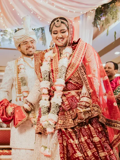 A candid moment of happiness during the wedding rituals. The groom smiles lovingly at his bride as they participate in the ceremony, showcasing the unscripted emotions that I strive to capture.