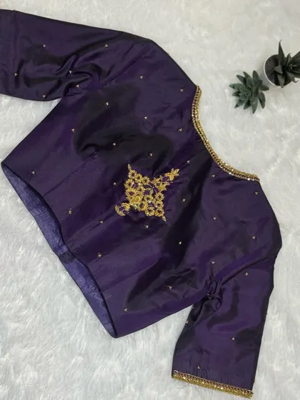 A majestic purple blouse with a single, elegant hand-embroidered motif.