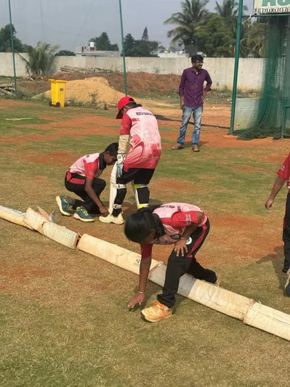 Players help prepare the pitch covers, learning about all aspects of the game and demonstrating teamwork off the field.