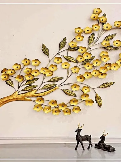 A beautiful representation of nature, this wall art features a branch laden with delicate golden flowers. Handcrafted from wrought iron, this piece brings a touch of organic elegance and antique charm to your living space.