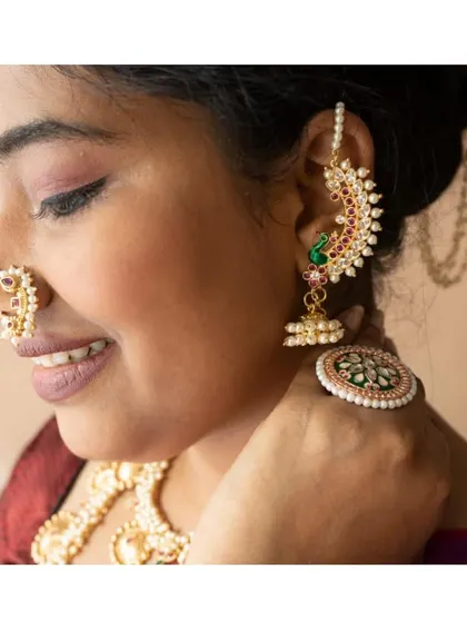 A perfect side profile showing a complete Maharashtrian look with our peacock-themed karnaful, a traditional nath, and a statement ring.