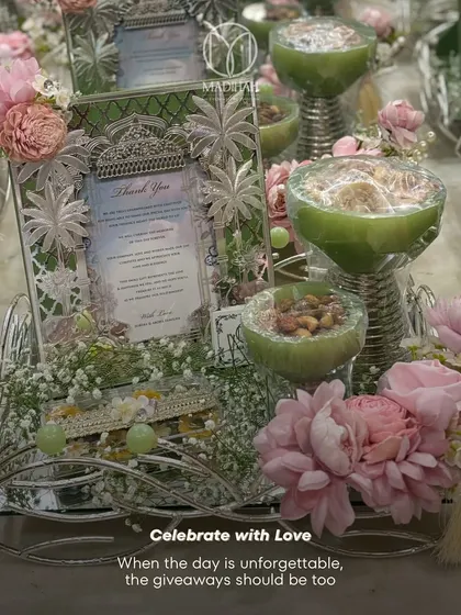 Celebrate with love. This pastel green and pink Sagan hamper is designed to be as unforgettable as the day itself, combining a silver frame, dry fruit bowls, and floral accents for a beautiful presentation.
