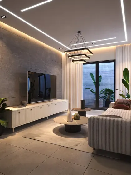 This living area combines a neutral striped sofa with a fluted white media console. The space is illuminated by modern linear lighting and a square chandelier, with large glass doors opening to a patio.