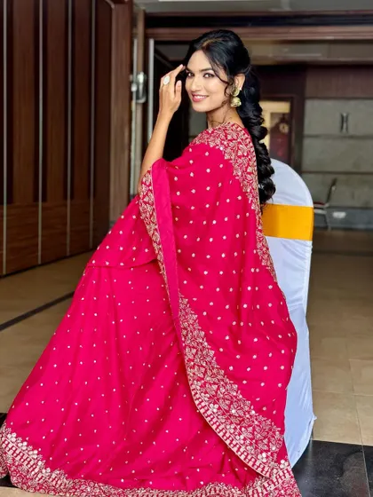 A full view of this stunning pink lehenga. The makeup is radiant and the intricate mermaid braid adds a touch of modern elegance, perfect for a wedding reception or sangeet.