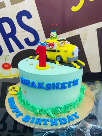 A 2kg Cocomelon cake with the yellow school bus on top for a first birthday.