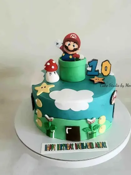 A Super Mario themed cake for a 10th birthday. This design brings the classic video game to life with Mario, mushrooms, and piranha plants.