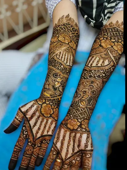 A beautiful full-arm design with striped patterns on the palm, creating a unique and modern twist on traditional mehndi.