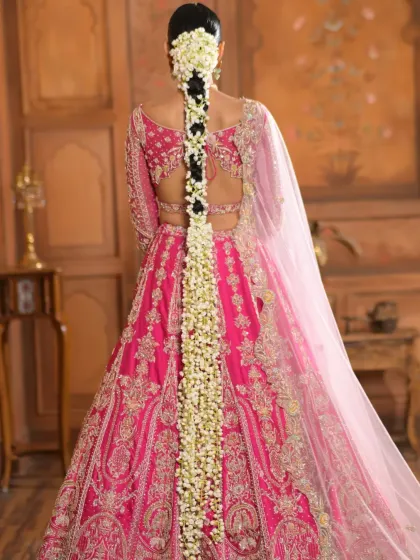 A full-length view of a classic South Indian bridal braid, generously adorned with fragrant jasmine flowers (gajara). This timeless hairstyle is perfect for traditional ceremonies and is designed to look elegant from every angle.
