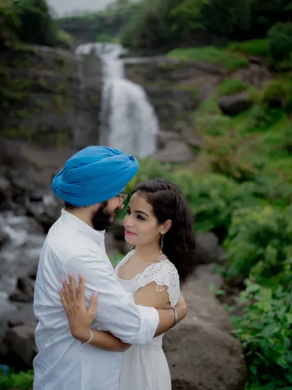 A romantic embrace with a majestic waterfall as the backdrop. I specialize in destination pre-wedding photography, finding epic locations to match your love story.