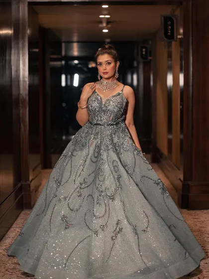 Our mint shimmer organza gown is a vision of elegance. The flared silhouette is encrusted with sparkling sequins and crystals, creating a look that is both sophisticated and breathtakingly beautiful.
