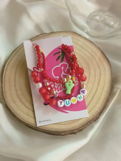 The complete red stack bracelet set for Yumna, presented on our Barbie-themed backing card.