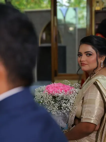 A candid shot of the bride looking back at her groom during their church wedding, a moment filled with love.